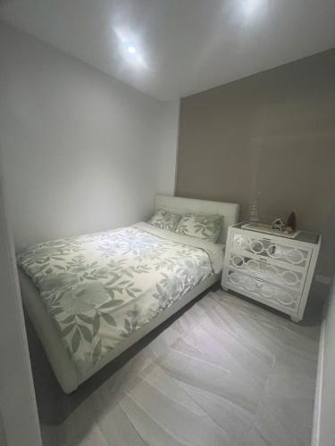 a small bedroom with a bed in the corner at The Cosy Beach Nook 2BR Near Airport & Beach in Sydney