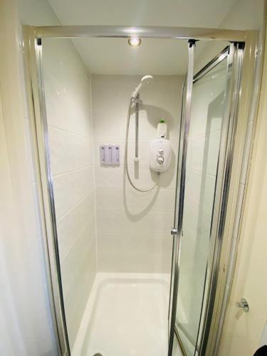 a shower in a bathroom with a glass shower stall at Stay at LL in Doncaster
