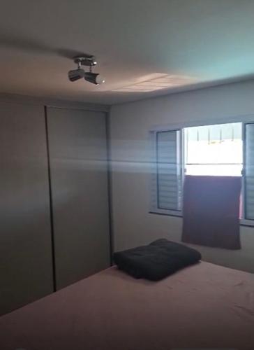 a bedroom with a bed and a ceiling fan at Aconchego in Cascavel