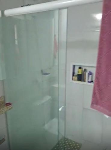 a shower with a glass door in a bathroom at Aconchego in Cascavel