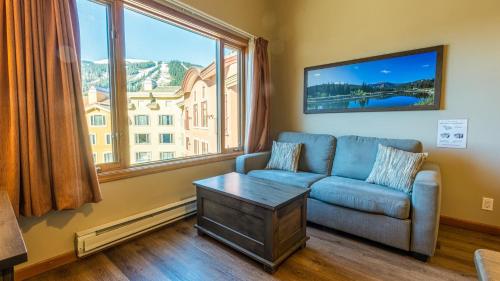 a living room with a couch and a large window at Cahilty #454 home in Sun Peaks