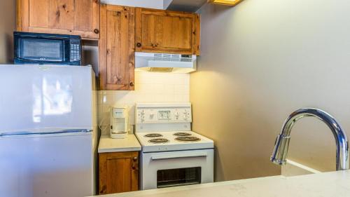 a kitchen with a white stove and a refrigerator at Cahilty #454 home in Sun Peaks