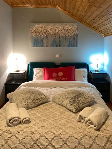 a bedroom with a large bed with pillows and avertisement at Elation Woodhouse in Elati