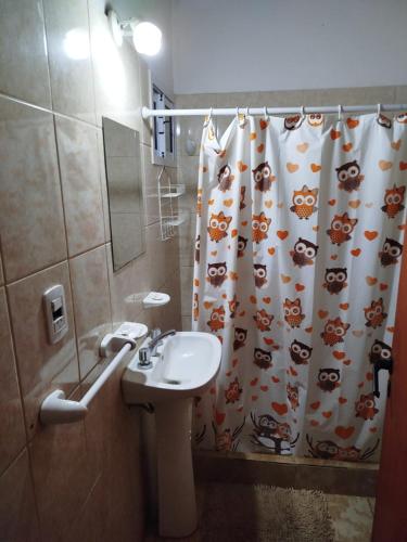 a bathroom with a sink and a shower curtain at Tu Destino in San José