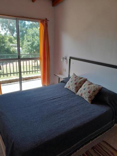 a bedroom with a bed and a large window at Tu Destino in San José