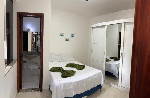a bedroom with a bed and a sink and a mirror at Apê de Mainha in Ilhéus