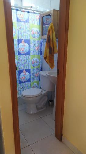 a bathroom with a toilet and a sink at Suite Crucita in Crucita