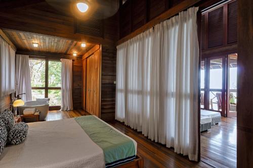 a bedroom with a bed and a large window at Secret Bay in Portsmouth
