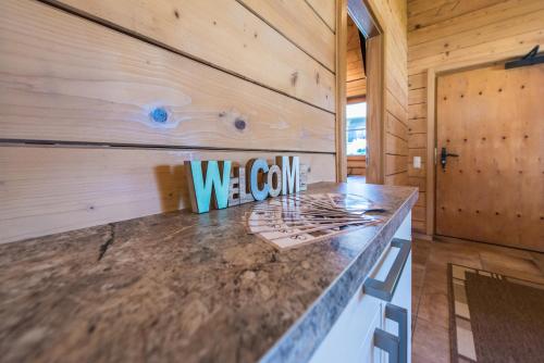 a kitchen with a welcome sign on a counter at Samerhäusl in Bruck an der Großglocknerstraße