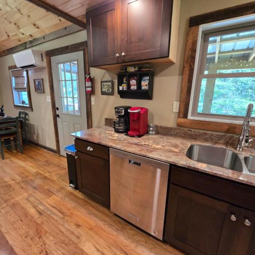 a kitchen with a sink and a counter top at Couples Getaway Cabin with a Loft Bed - Firepit - Creek Access in Dahlonega