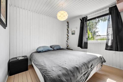 a bedroom with a bed in a room with a window at SL350-Slagelse-Spaettevej-14 in Slagelse