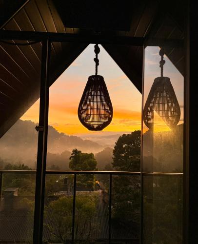 a view of a sunset from a window at Villa Mount View in Gampola