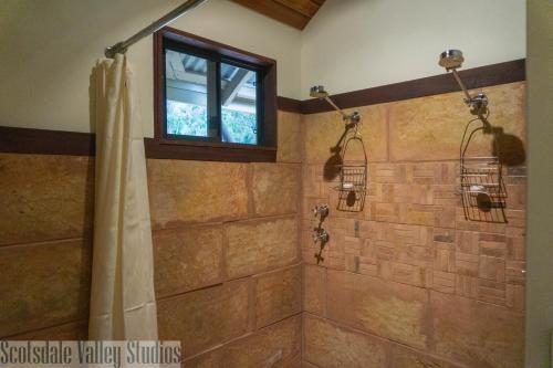 a bathroom with a shower with a window at Scotsdale Valley Studios in Harewood