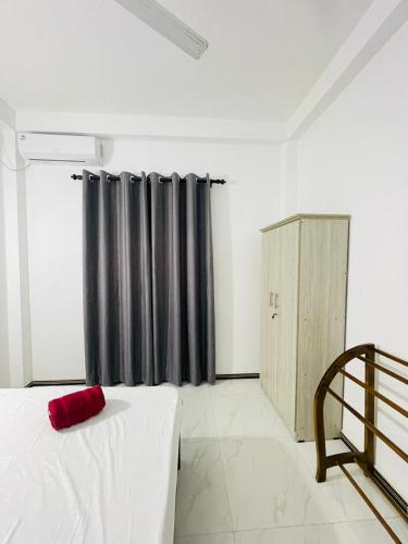 a bedroom with two beds and a black curtain at SH Villa in Weligama