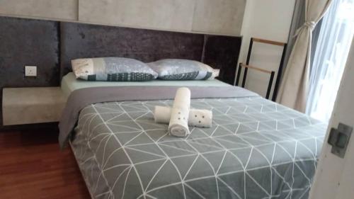 a bed with two white pillows on it at Tasneem Guesthouse in Shah Alam