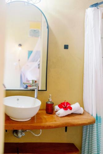a bathroom with a sink and a mirror at Finca Aisa -Boutique bungalows in Ometepe island in Santa Cruz