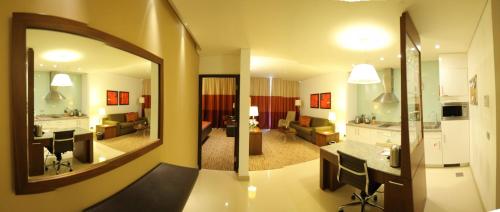 a living room and a kitchen with a mirror at Staybridge Suites Beirut by IHG in Beirut