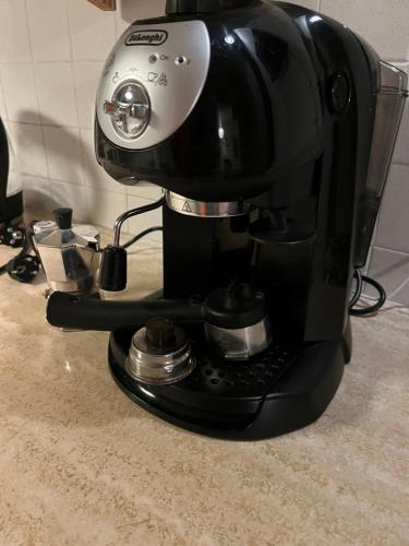 a black coffee maker sitting on top of a counter at Tuscia Home Backpackers in Orte