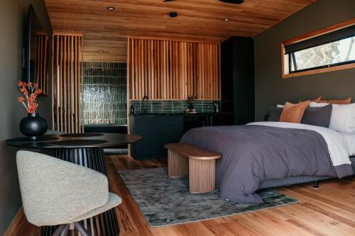 a bedroom with a bed and a table at 3 Acres by the Moyne in Port Fairy