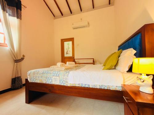 a bedroom with a bed and a desk with a lamp at Bella Vista Ella in Ella