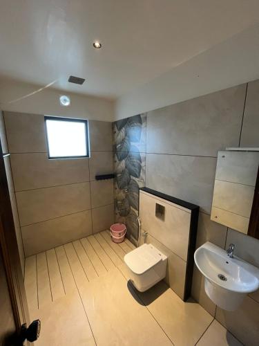 a bathroom with a toilet and a sink at Camplights Stays in Tariyod