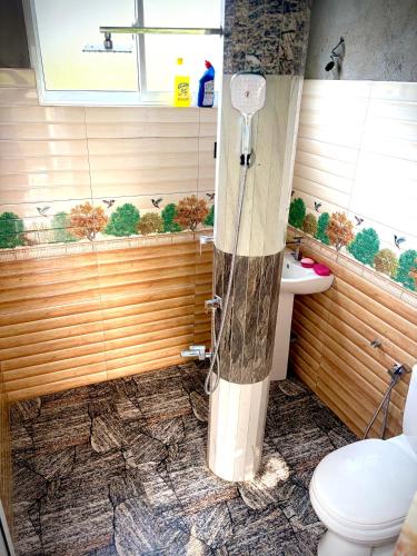 a bathroom with a shower and a toilet and a sink at Sandaruwan villa in Ratgama Hegoda
