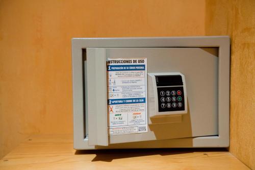 un horno microondas con una calculadora encima en Hotel Cordón, en Burgos