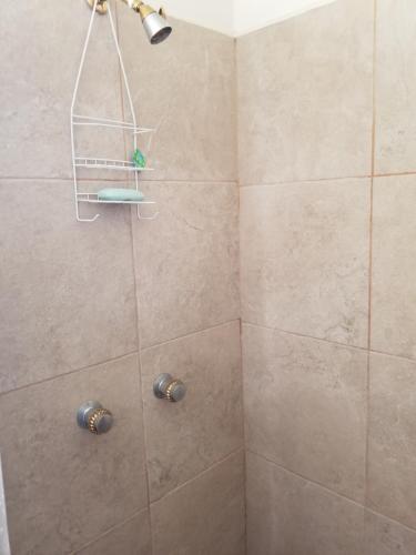 a bathroom with a shower with a shower head at Depa Jardines Anahuac in Mexicali