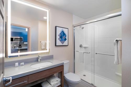 a bathroom with a toilet and a sink and a shower at Candlewood Suites El Paso by IHG in Sunrise Acres
