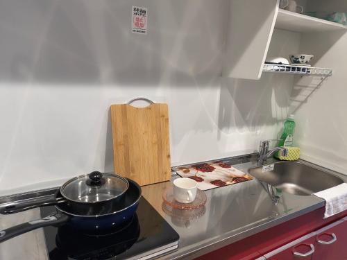 a kitchen with a sink and a pot on a stove at 北滨Grace DAY 101 in Takamatsu