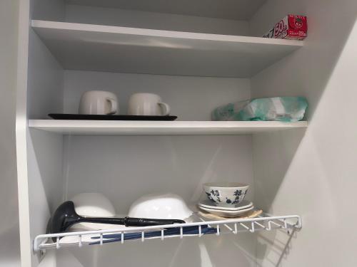 a white shelf with cups and dishes on it at 北滨Grace DAY 101 in Takamatsu