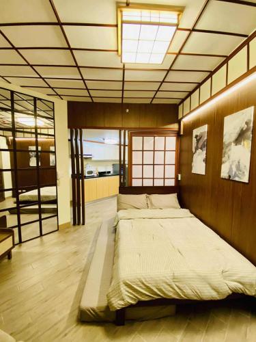 a bedroom with a large bed in a room at Okaeri Place - One Regis in Bacolod