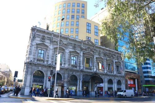 a large building with a clock on the front of it at Hotel Diego de Almagro Santiago Centro in Santiago