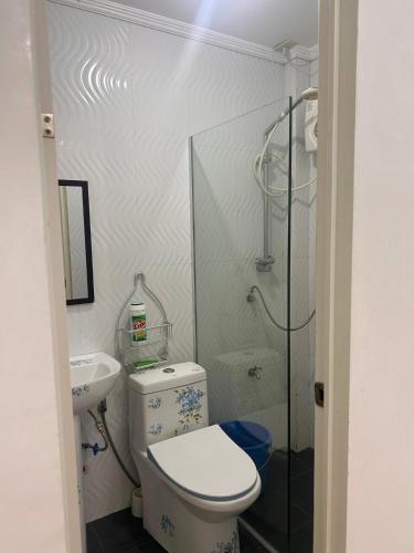 a small bathroom with a toilet and a sink at Kole & Kobe Haven in Dipolog
