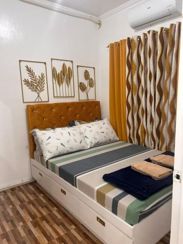 a bedroom with a bed with a headboard at Kole & Kobe Haven in Dipolog