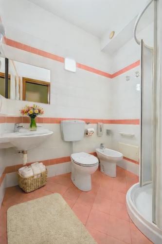a bathroom with a toilet and a sink and a tub at Hotel Oberje Dla Viere Oulx - Check-in Automatico 24h in Oulx