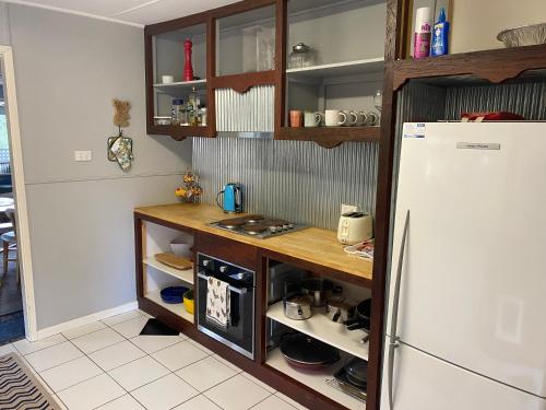 a kitchen with a counter and a refrigerator at Winganna Farm in Peel