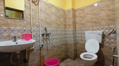 a bathroom with a toilet and a sink at KEBA Dream Grand in Secunderabad