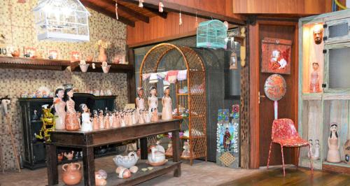 a room filled with lots of vases and other items at Diamante Palace Hotel in Diamantina