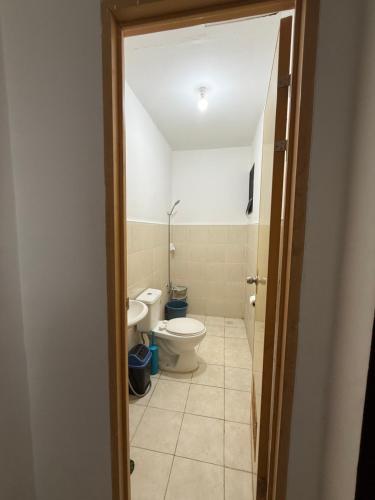 a bathroom with a toilet and a sink at Private Cozy Home in Tagum