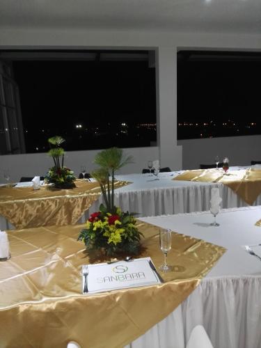 a row of banquet tables with white table cloth at Gran Hotel Internacional Sanbara in Arauca