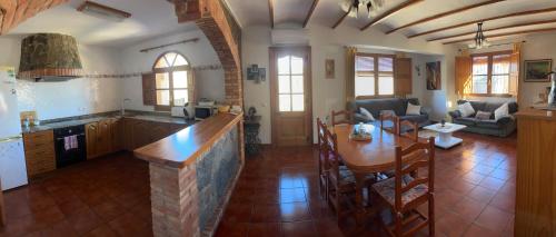a kitchen and living room with a table and chairs at RuralRusticHome in Altura