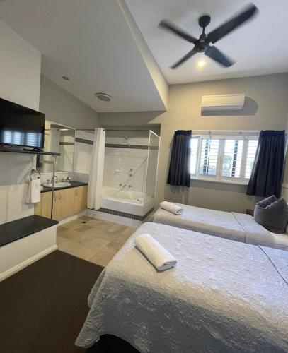 two beds in a room with a bathroom at Margarets Forest in Margaret River Town
