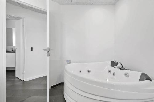 a white bath tub in a white bathroom at G331-Lemvig-Myntevej-31 in Lemvig