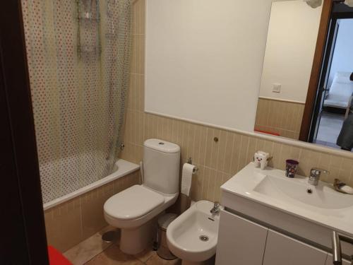 a bathroom with a toilet and a sink and a mirror at Beachfront on Isla Canela in Punta del Caimán