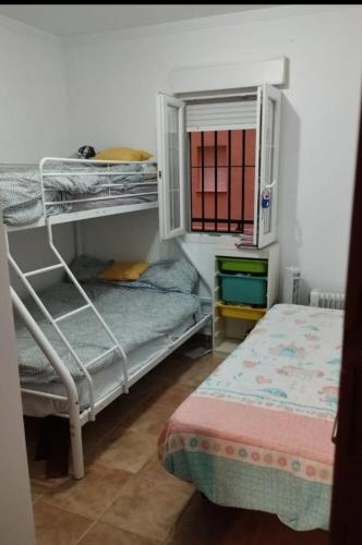 a bedroom with two bunk beds and a bed at Beachfront on Isla Canela in Punta del Caimán