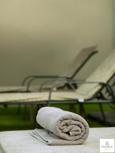 a towel sitting on top of a bed at Kulala Stays Lodge in Livingstone