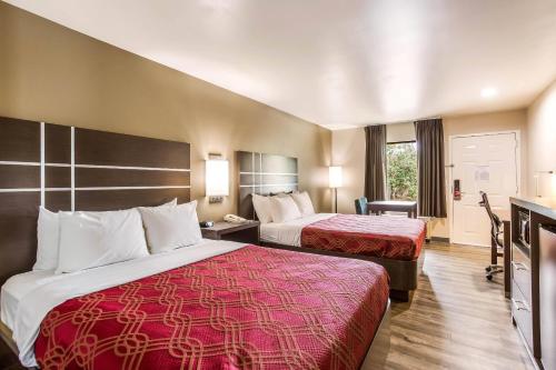 a hotel room with two beds and a television at Econo Lodge Inn & Suites Murfreesboro Shopping District in Murfreesboro