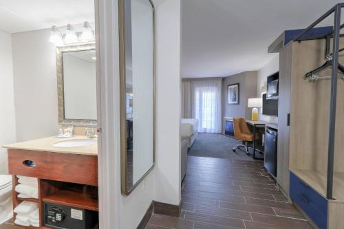 a bathroom with a sink and a mirror at Comfort Inn & Suites at Dollywood Lane in Pigeon Forge