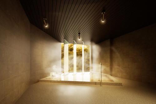 a room with a window with lights on the wall at Aizu Higashiyama Onsen "Tsuki no Akari" self-service INN in Aizuwakamatsu